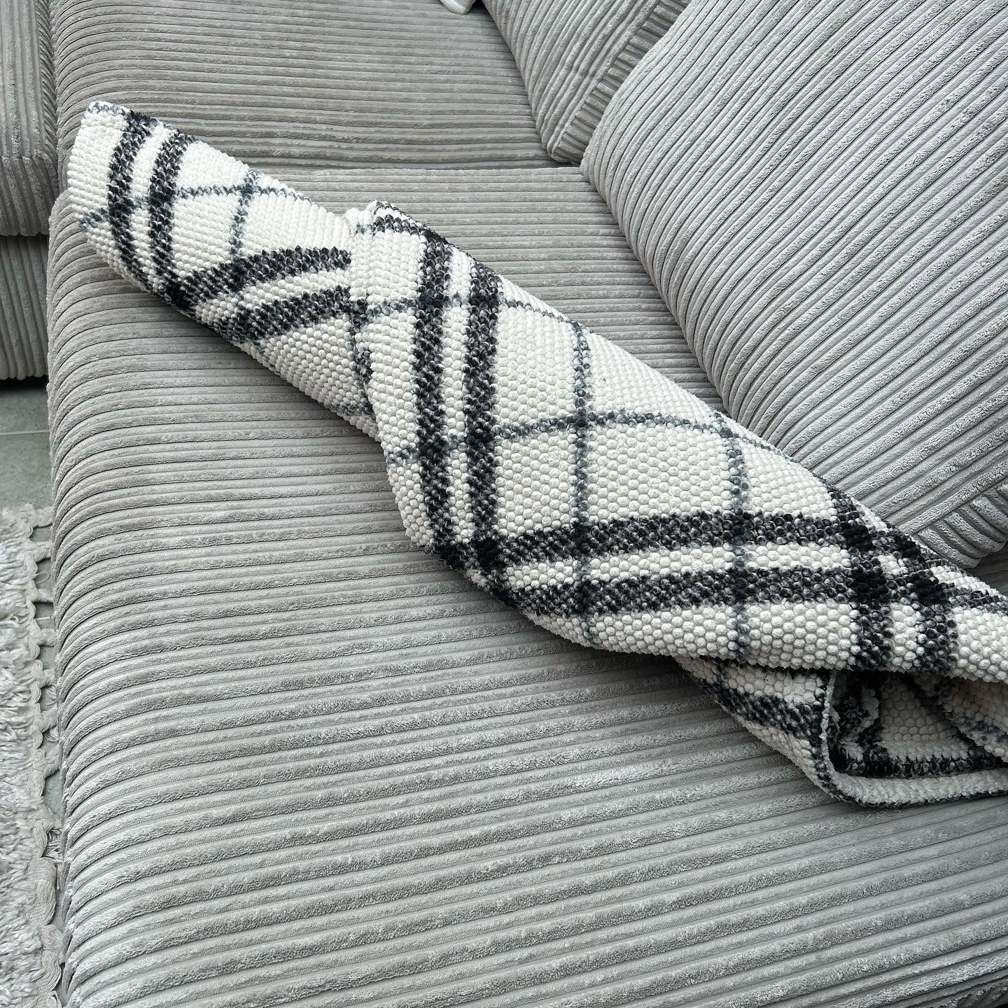 Sofa cushions and throw arranged